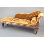 A William IV carved rosewood chaise longue upholstered in mustard coloured buttoned material, raised