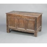 An 18th Century oak coffer of panelled construction with hinged lid and original iron handles 60cm h