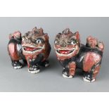 A pair of 19th/20th Century painted carved wooden figures of standing Dogs of Fo 22cm x 24cm x 12cm