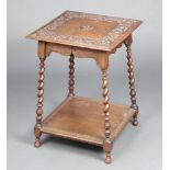 A Victorian square carved oak 2 tier occasional table, the top carved CMG, raised on spiral turned