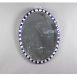 A 19th Century Irish oval plate mirror contained in a blue and clear faceted glass frame 59cm h x