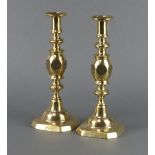 A pair of Victorian brass candlesticks with bullseye decoration, complete with ejectors, the bases