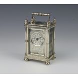 A Mappin & Webb silver carriage clock, profusely engraved with flowers, feathers and scrolls, the