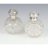 A near pair of Victorian silver mounted globular glass toilet jars Birmingham 1897, 1899, 11cm