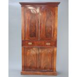 A Victorian mahogany bookcase on cabinet, the upper section with moulded cornice, the shelved