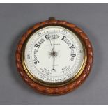 An aneroid barometer with 18cm porcelain dial marked Bobby and Jennings Ipswich, contained in a