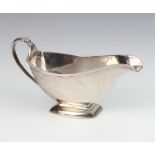 An Art Deco silver sauce boat with scroll handle Birmingham 1930 148 grams