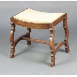 A 17th Century style rectangular oak dressing table stool on outswept supports with H framed