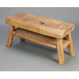 A hardwood Naga rice pounding table table with undertier raised on outswept supports 48cm h x 97cm w