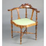 An Edwardian inlaid mahogany corner chair with upholstered seat, raised on turned supports with H