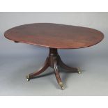 A Georgian oval snap top breakfast table raised on a gun barrel turned column with splayed supports,