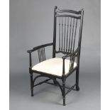 A Sussex style ebonised stick and rail back chair in the William Morris manner, with upholstered