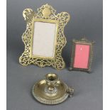 An 18th/19th Century circular gilt metal chamber stick 5cm x 8cm, a pierced brass easel photograph