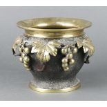 A polished bronze jardiniere with grape and vinous decoration raised on a spreading foot 15cm h x