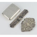 An engine turned silver cigarette case, a Thai niello comb holder and a white metal buckle 120 grams