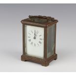 A French 8 day carriage timepiece with 6cm enamelled dial and Roman numeral contained in a gilt case