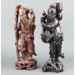 An Eastern carved hardwood figure of a standing deity with bird 40cm h x 13cm and 1 other 42cm x