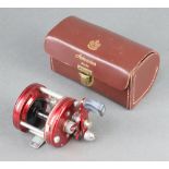 An Abu Ambassadeur 5000 fishing reel in leather case