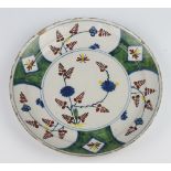 An 18th Century Continental Delft plate decorated with stylised flowers and insects 22cm There is
