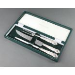 A cased silver plated lily pattern carving set