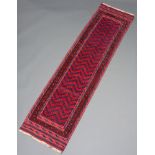A blue and red ground Meshwani runner with overall geometric design 274cm x 64cm