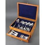 A modern canteen containing a set of silver plated lily pattern cutlery comprising 12 coffee spoons,