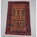 A brown, red and blue ground Belouche prayer rug 137cm x 85cm