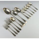 A part canteen of Edwardian silver Old English pattern cutlery comprising 1 basting spoon, 2