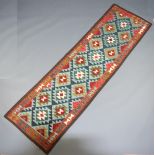 A green, white and tan ground Maimana Kilim runner with all over geometric designs 293cm x 85cm