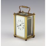 A carriage clock with enamelled dial Roman numerals, contained in a gilt case complete with key 10cm