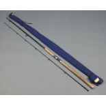 A Bruce Walker multispin 10', 2 piece spinning fishing rod in blue cloth bag