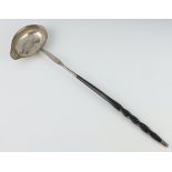 A William IV silver ladle with engraved stem and whale bone handle, London 1834