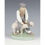 A Royal Copenhagen figure of a shepherd with 2 sheep no.627 21cm