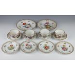 A German porcelain tea set comprising 4 tea cups, 4 saucers (1 riveted), 4 small plates, 2 medium