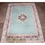 A Turkey green ground and floral patterned carpet with central medallion 343cm x 252cm Signs of