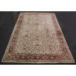 A terracotta and cream ground machine made Persian style carpet 500cm x 337cm A 50cm x 12cm patch to