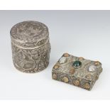 A repousse Sterling silver circular box decorated with figures and having a wooden interior 9cm,