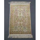 A yellow ground silk Persian rug with deep fringe 82cm x 53cm