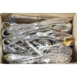 A quantity of silver plated lily pattern utensils including tongs, nips, candle snuffers etc