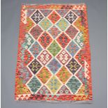 A green, white and orange ground Chobi Kilim rug with all over diamond design 150cm x 100cm