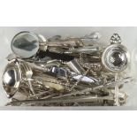 A quantity of silver plated lily pattern cutlery and utensils including magnifying glass, tea