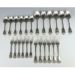 A matched canteen of George IV and Victorian silver fiddle and shell pattern cutlery comprising 6