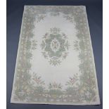 An Indian white and floral ground rug 243cm x 152cm