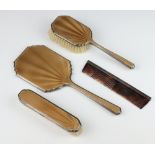 A silver and guilloche 3 part dressing table set comprising hand mirror, hair brush and clothes