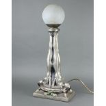 G Leonardi, an Art Deco plaster table lamp supported by 2 naked ladies with crackle glass ball