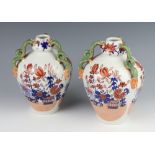 A pair of Masons ironstone ovoid vases with serpent handles decorated with flowers 21cm