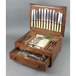 An oak canteen containing a set of silver plated cutlery for 6