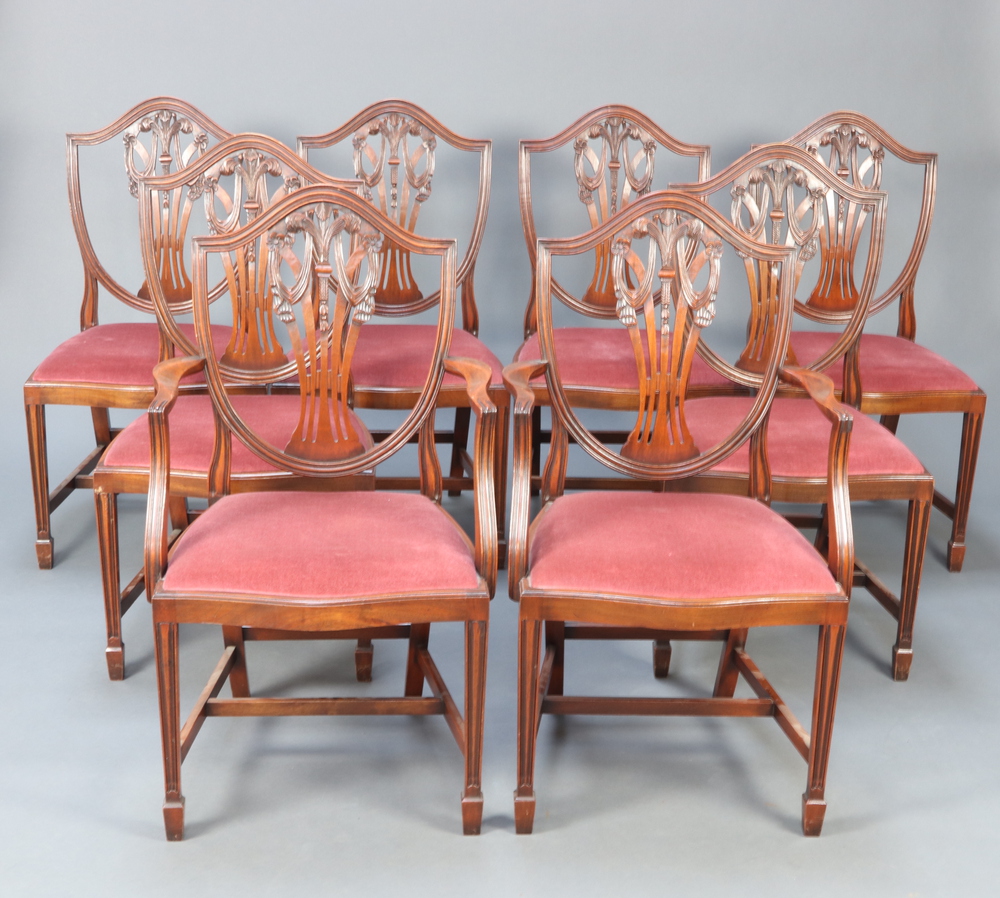 A set of 8 20th Century Hepplewhite style mahogany camel back dining chairs with pierced vase shaped