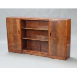 Brickers, an Art Deco inverted breakfront mahogany bookcase, the centre section fitted adjustable