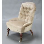 A Victorian buttoned nursing chair with metal frame, upholstered in mushroom coloured material,